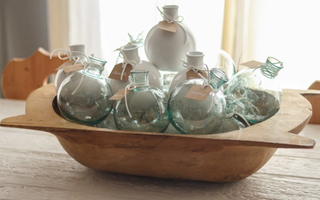 The Sphere Bud Vase is mouth-blown by European artisans and designed to sit slightly off center on your tabletop. A sleek coffee table accent or shelf styler, this sphere vase is elegantly imperfect due to the recycled nature of the glass. 