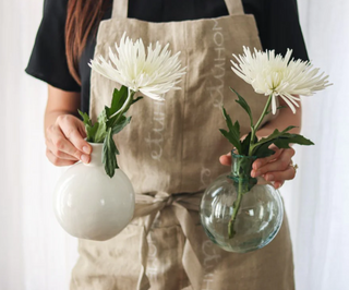 The Sphere Bud Vase is mouth-blown by European artisans and designed to sit slightly off center on your tabletop. A sleek coffee table accent or shelf styler, this sphere vase is elegantly imperfect due to the recycled nature of the glass. 