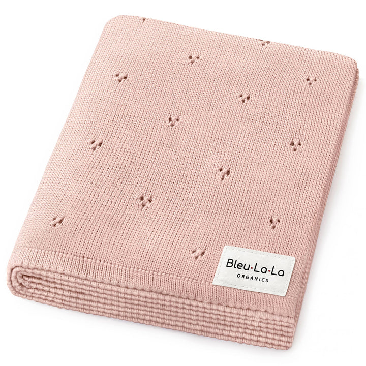 Pink knitted blanket with 'Bleu La La Organics' label on a white background