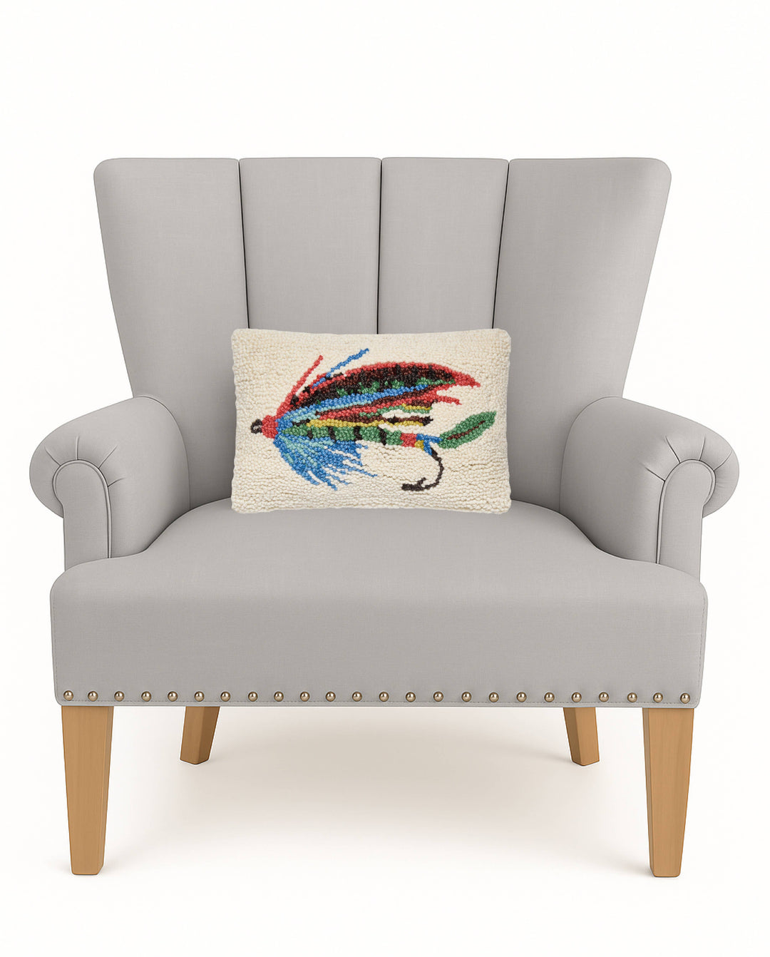 Gray armchair with a decorative pillow featuring a colorful fly on a white background