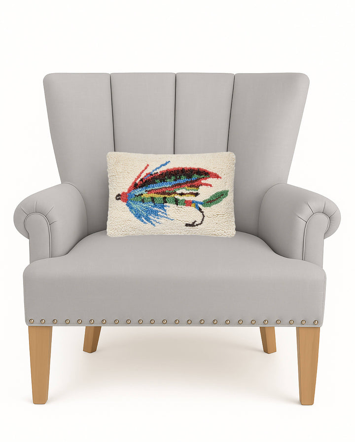 Gray armchair with a decorative pillow featuring a colorful fly on a white background
