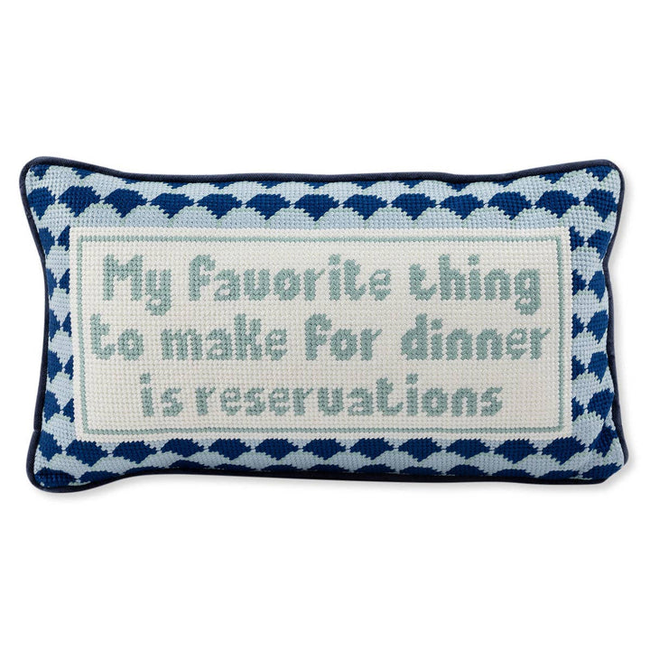 Decorative pillow with text 'My favorite thing to make for dinner is reservations' on a white background
