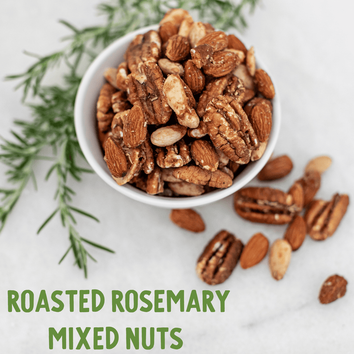 Roasted rosemary mixed nuts in a white bowl on a light background