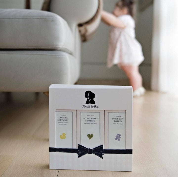 Product packaging with silhouette design on a blurred background of a living room.