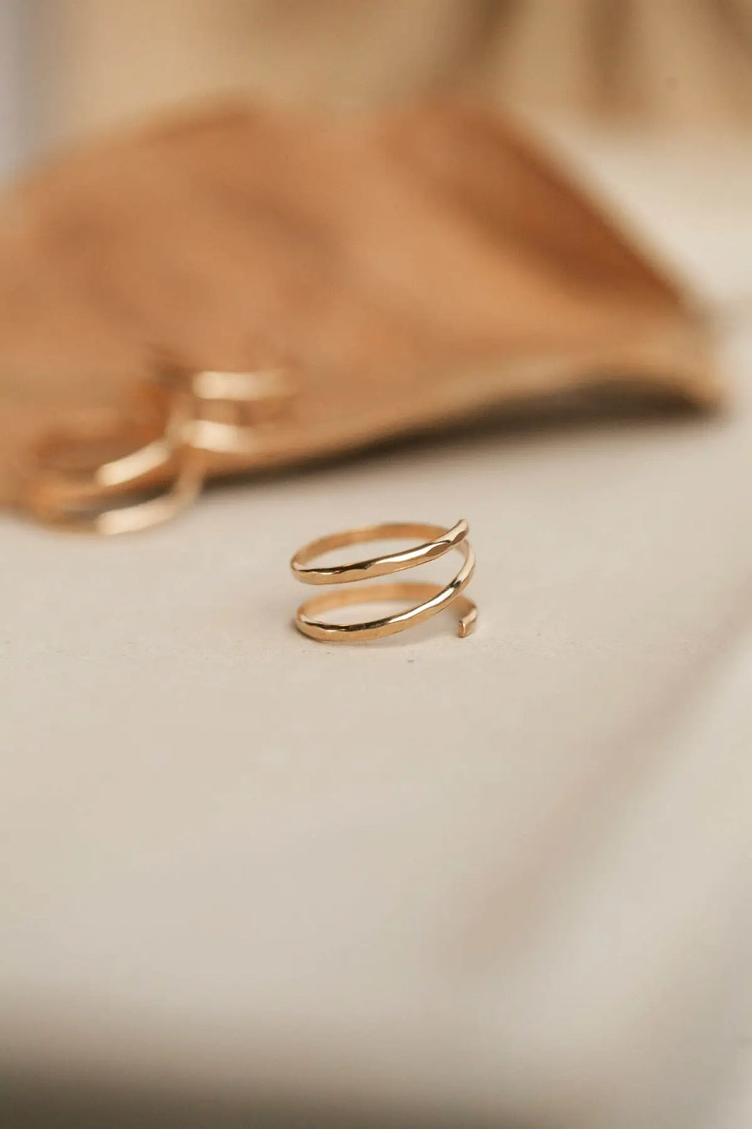 Gold ring on a soft beige background