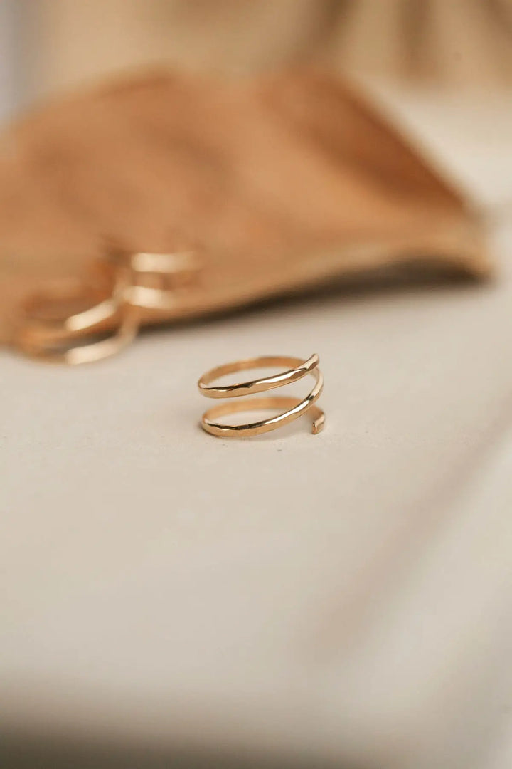 Gold ring on a soft beige background