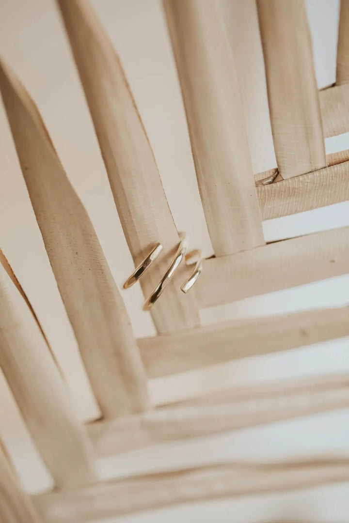 Close-up of gold rings on a woven surface
