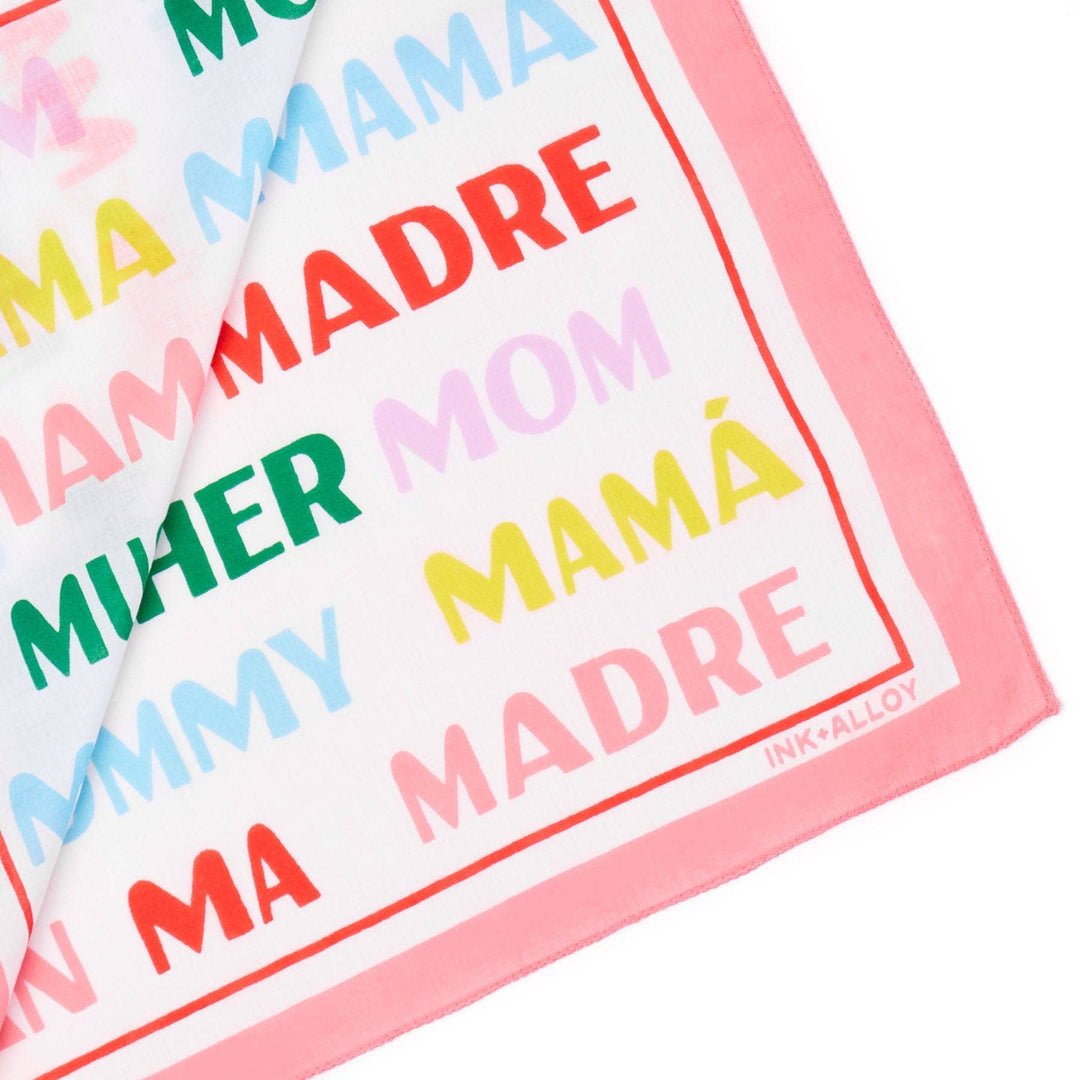 Colorful text towels with 'Mama', 'Mom', and 'Mamá' printed on them.