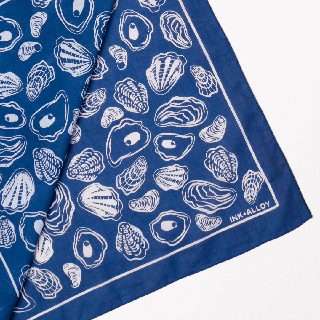 Blue bandana with white shell pattern and 'INK+ALLOY' branding