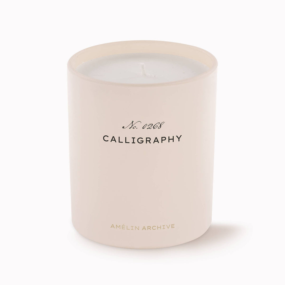 Beige candle with 'Calligraphy' text on a white background