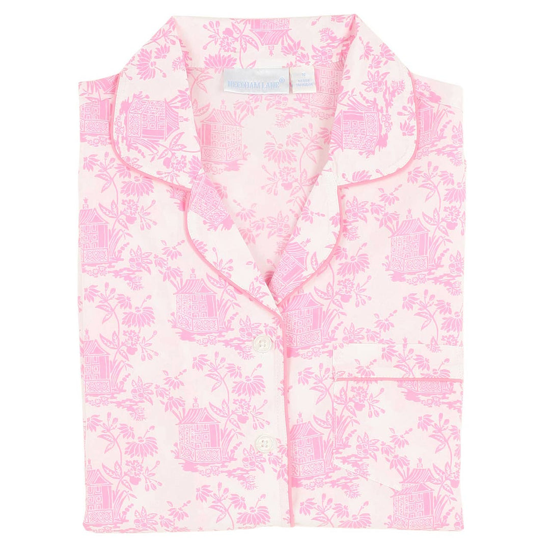 Pink floral pajama set with a tag on a white background