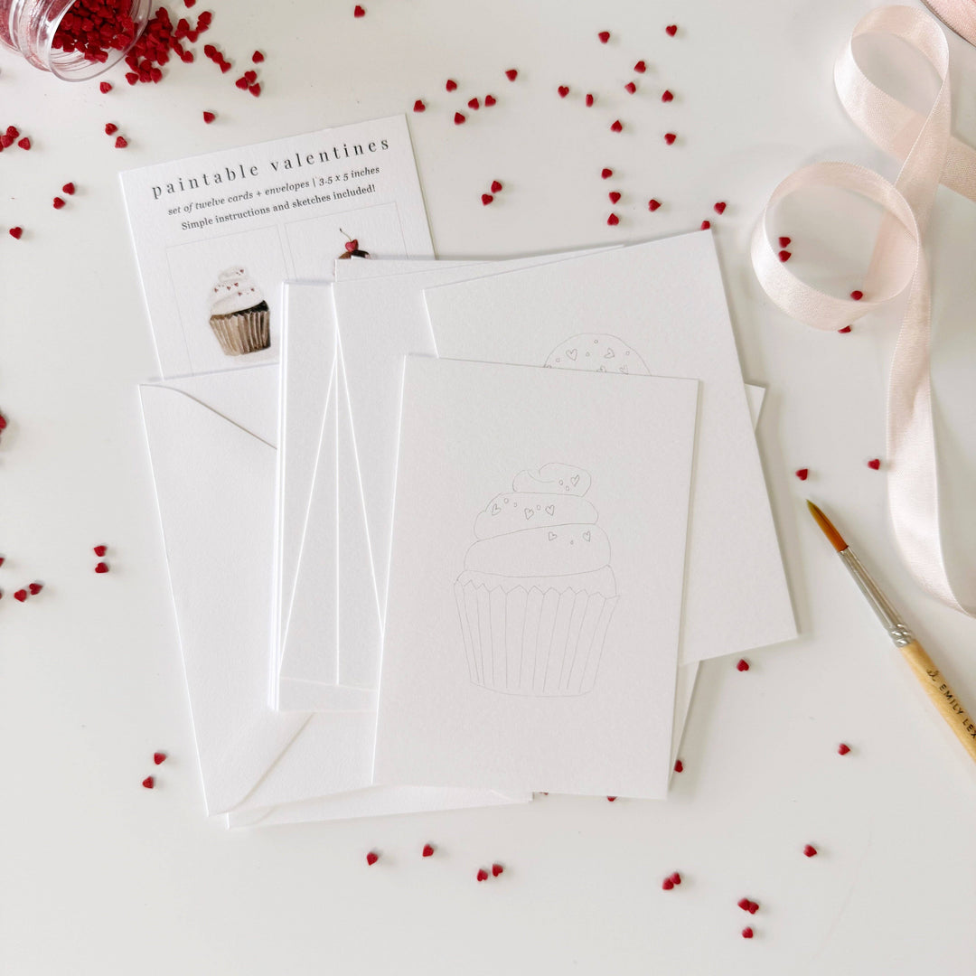 White card with envelope on a white surface with red decorative elements