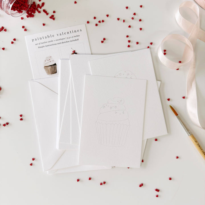 White card with envelope on a white surface with red decorative elements