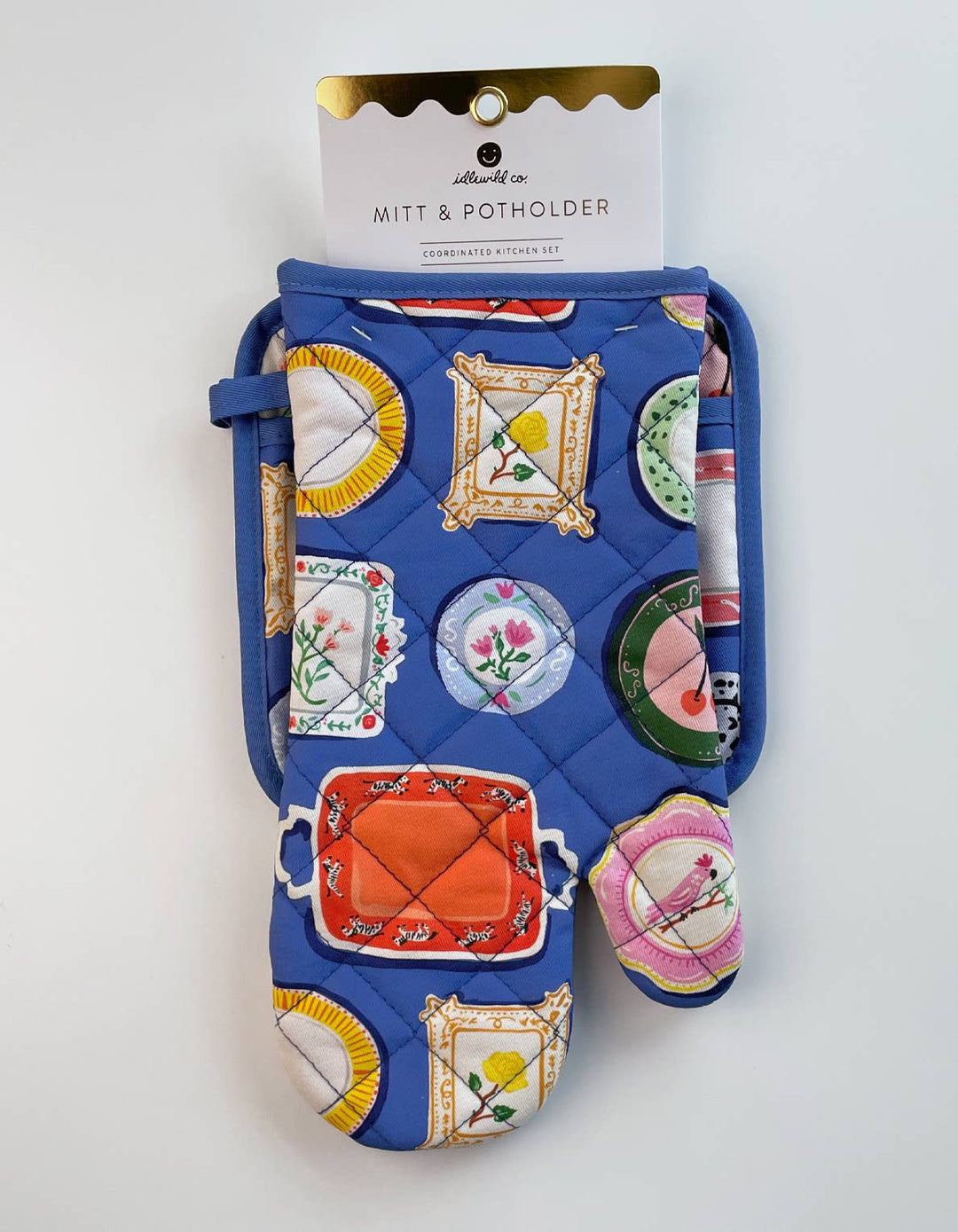 Quilted oven mitt and potholder set with colorful designs on a white background