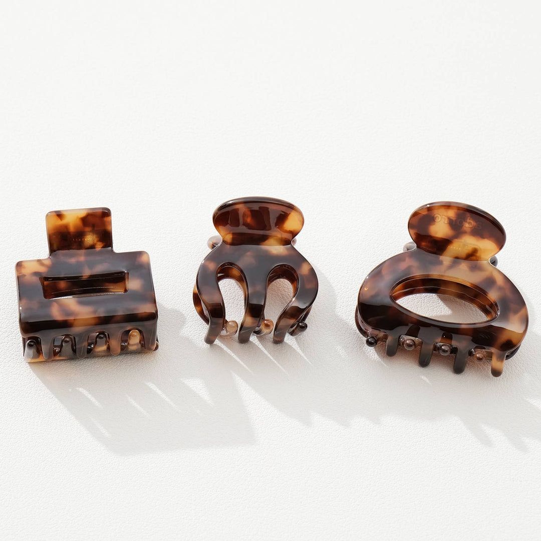 Three tortoiseshell hair clamps on a white background