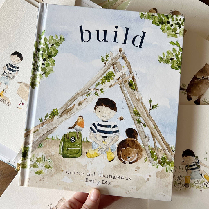 Children's book titled 'build' with illustrations of a boy, animals, and a treehouse.