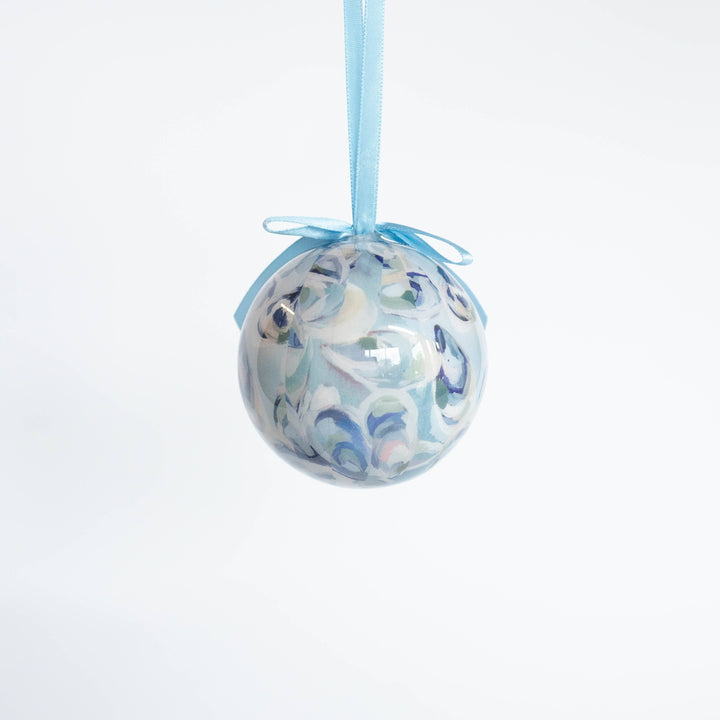 Decorative glass ball with blue ribbon on a white background