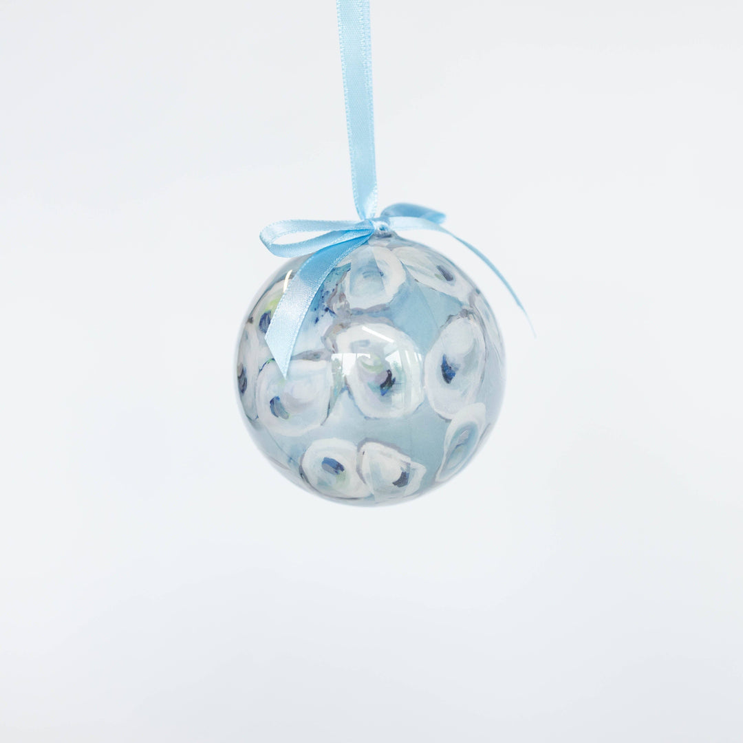 Decorative ball ornament with blue ribbon on a white background