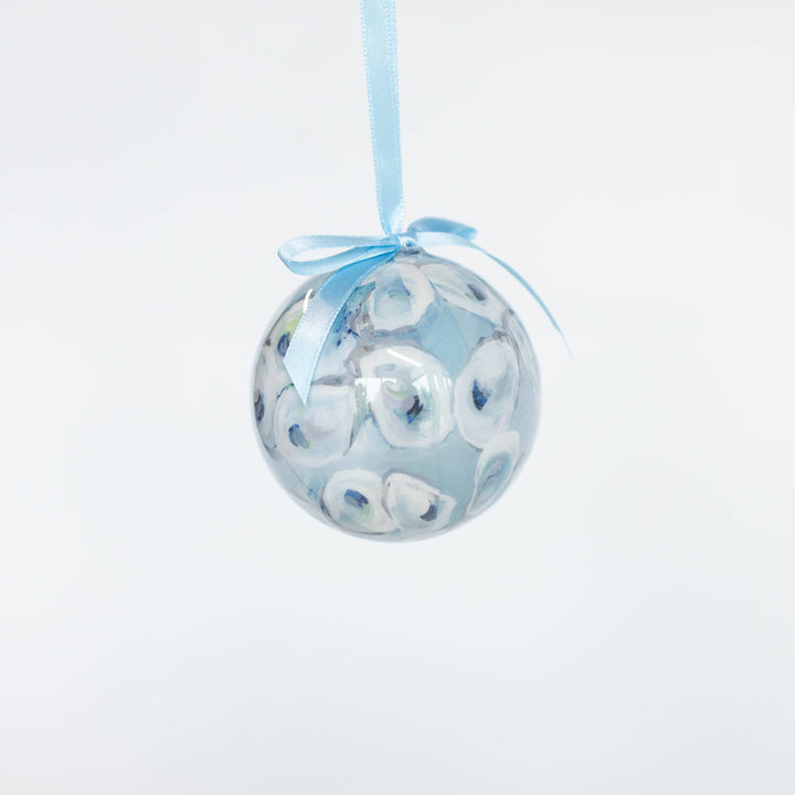 Decorative ball ornament with blue ribbon on a white background