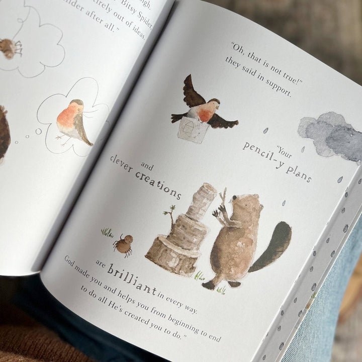 Open book with illustrations of animals and text on a wooden surface