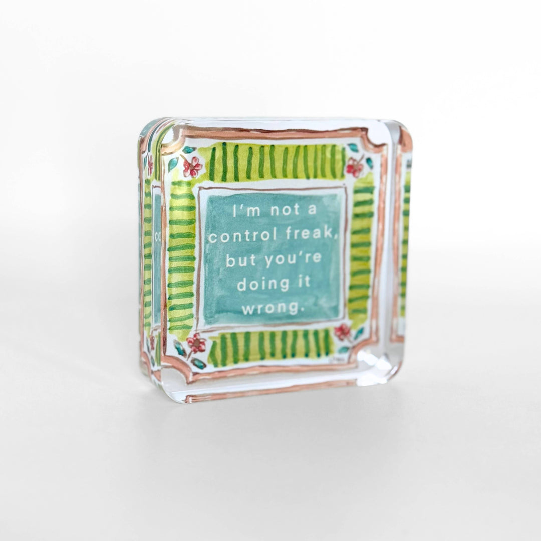 Decorative glass block with a humorous quote on a white background
