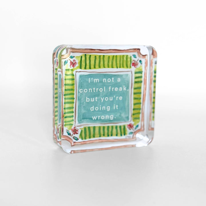 Decorative glass block with a humorous quote on a white background