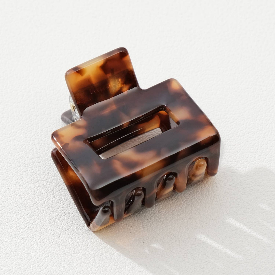 Tortoiseshell hair clip on a light gray background