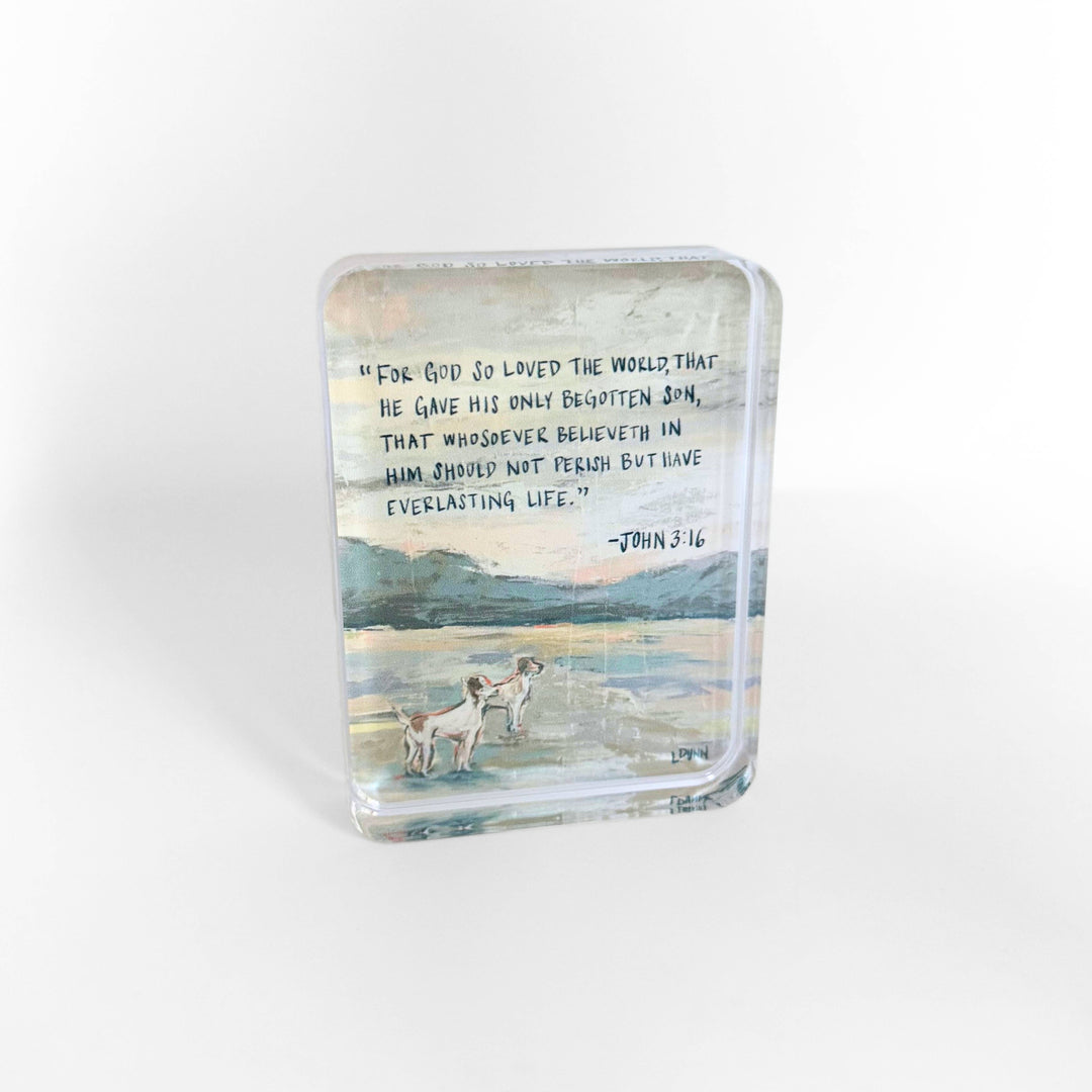 Glass block with a scenic design and text on a white background