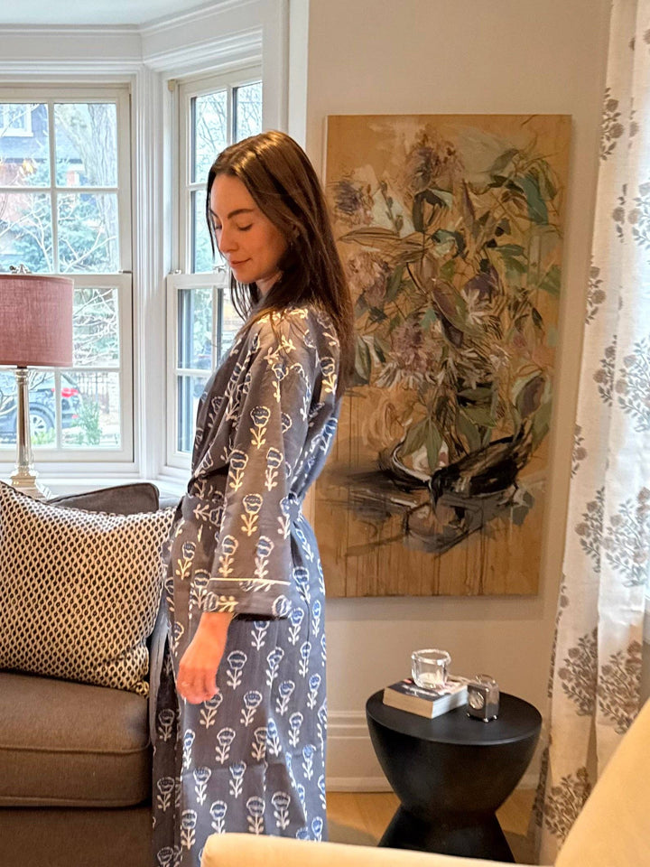 Woman in a living room with a painting on the wall