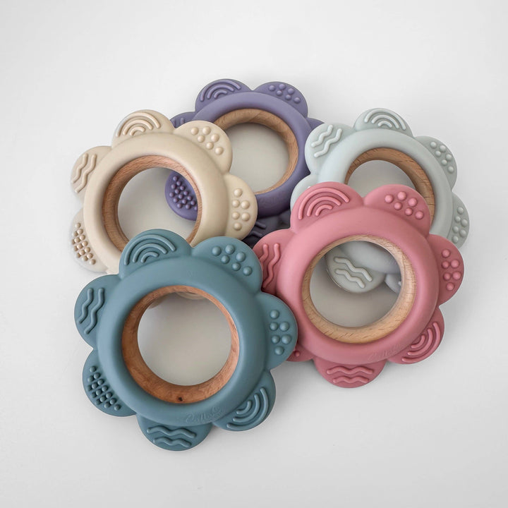 Set of colorful silicone teething rings on a white background