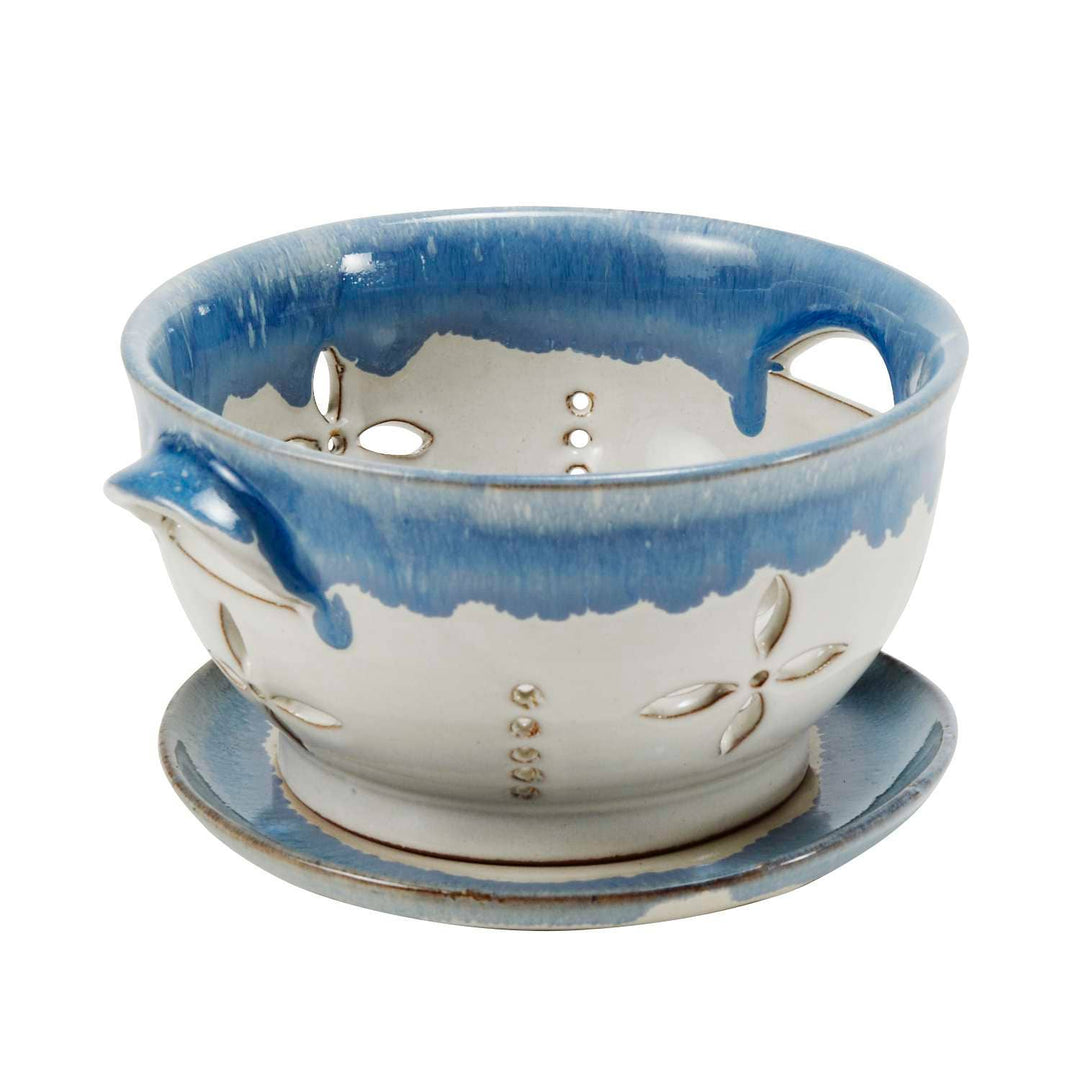Ceramic colander with blue and white design on a white background