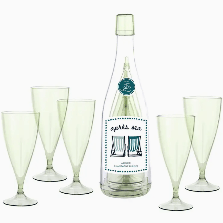 Bottle of 'Apres Sea' with six matching glasses on a white background