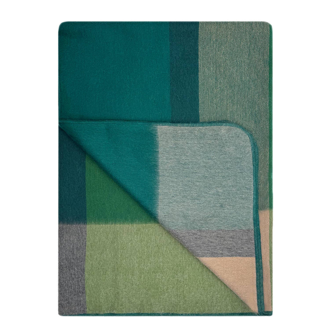 Folded plaid blanket with green and blue pattern on a white background