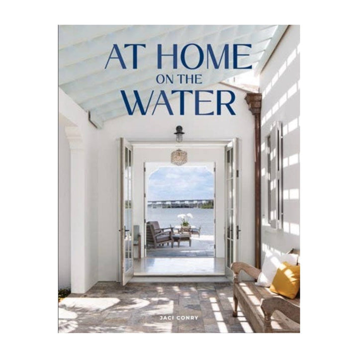 Book cover titled 'At Home on the Water' with a view of a waterfront house.