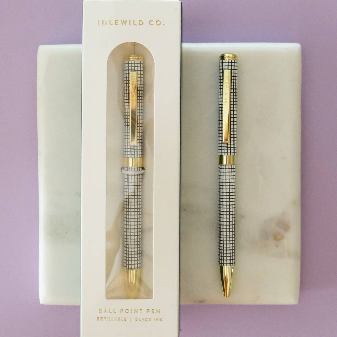 Black and silver pen set with packaging on a purple background