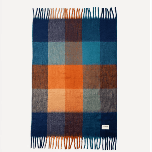 Blue and orange plaid blanket with fringe.