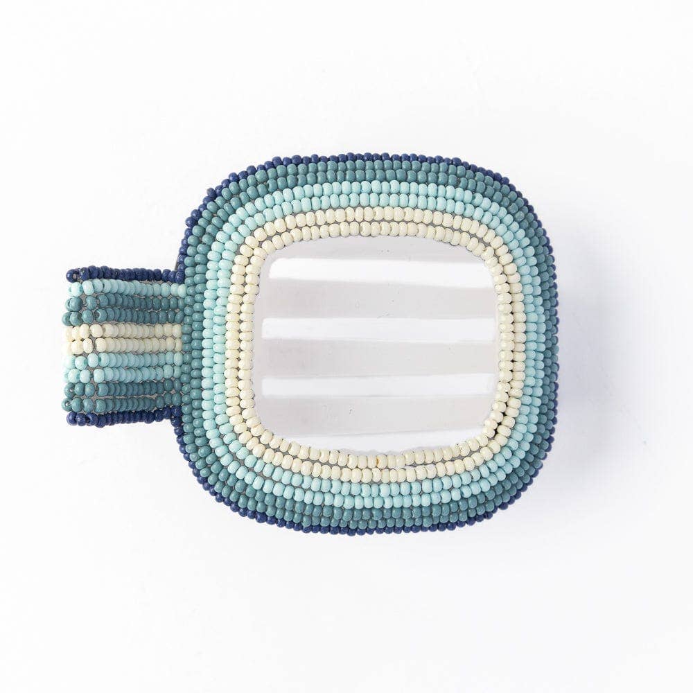 Decorative hair clip with beaded frame in blue and white gradient on a white background