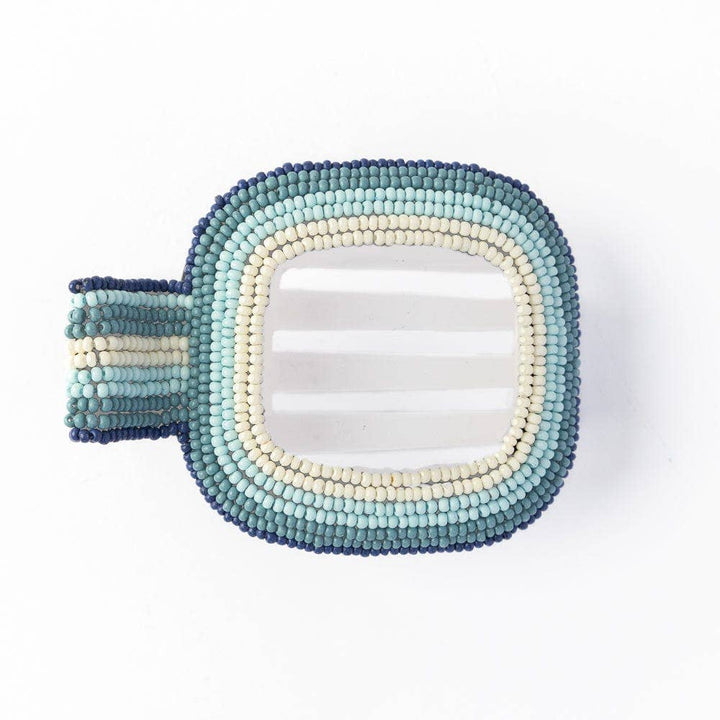 Decorative hair clip with beaded frame in blue and white gradient on a white background