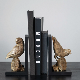 Featuring charming parrot shaped designs and an eye-catching gold finish, these decorative bookends are perfect for adding that special touch to your home decor.  4-1/2"L x 3-3/4"W x 7"H Resin Parrot Bookends, Gold Finish, Set of 2