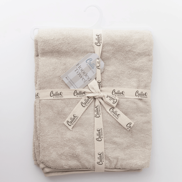 linen colored hooded baby towel folded on white background
