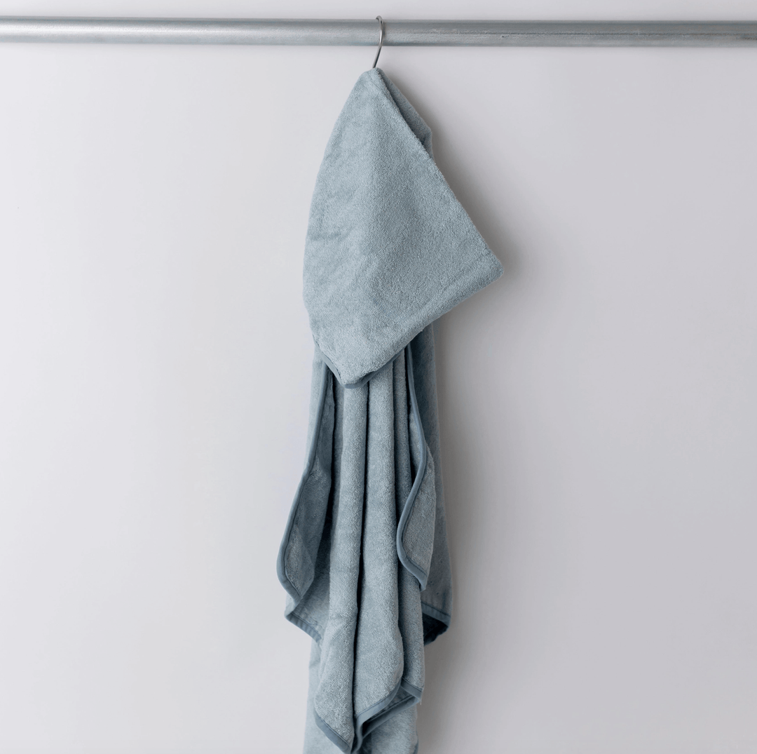 blue hooded baby towel hanging on hook