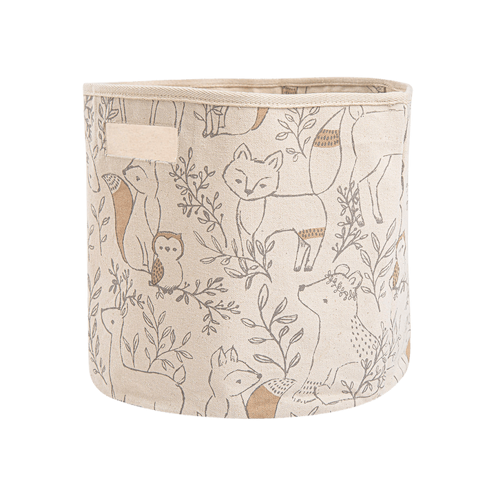 A fabric storage bin with a woodland animal print featuring foxes, a deer, an owl, and a squirrel in brown and beige tones on a cream background, with a fabric handle on the side.