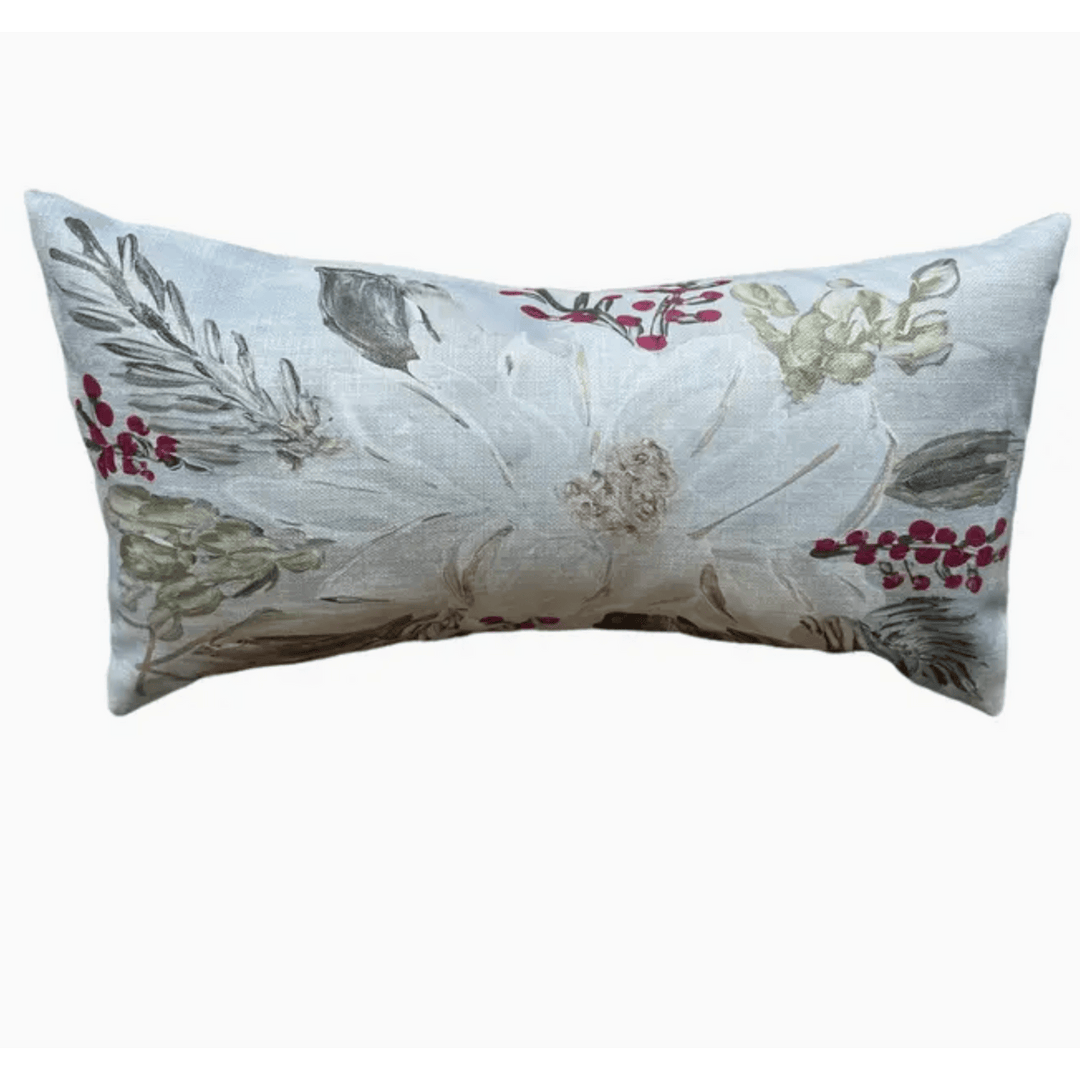 A rectangular lumbar throw pillow with a textured, woven floral pattern featuring a large white flower and green leaves accented with small red berry clusters, set against a plain white background.