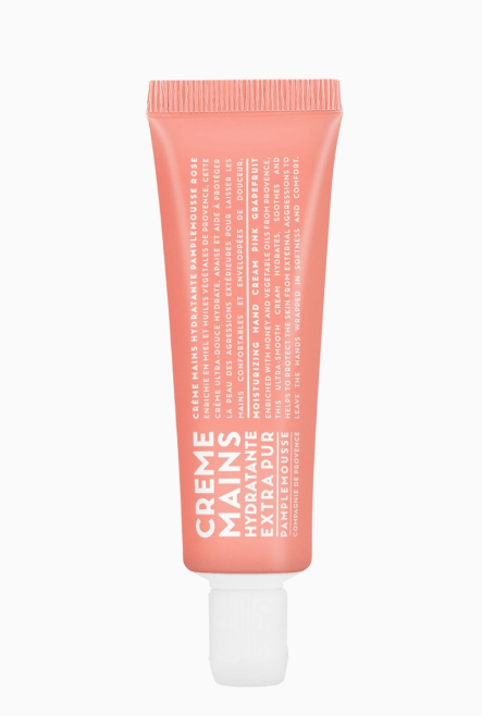 Pink hand cream tube on a white background