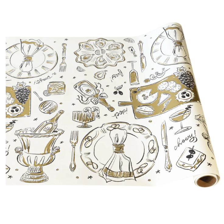 Roll of paper with gold and black dinner party illustrations on a white background