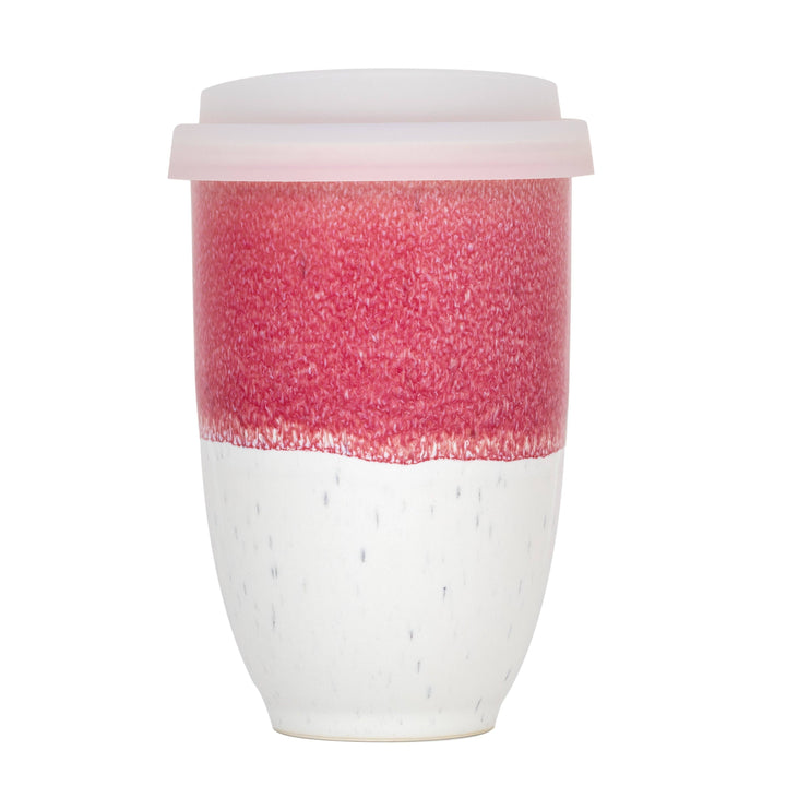 Reusable coffee cup with pink and white design on a white background