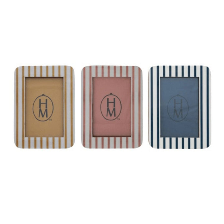 Three striped makeup products with 'HM' logo on a white background