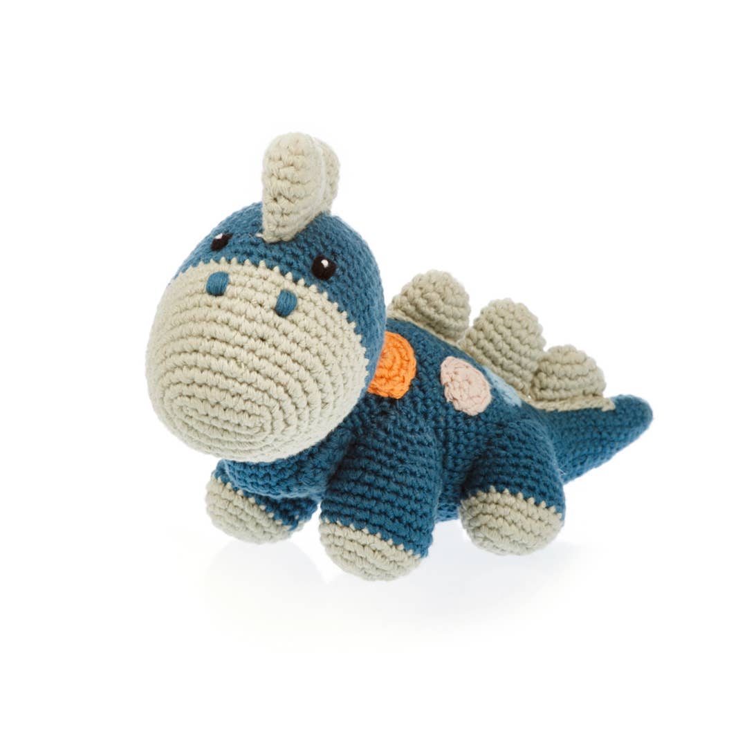 Crocheted dinosaur toy on a white background