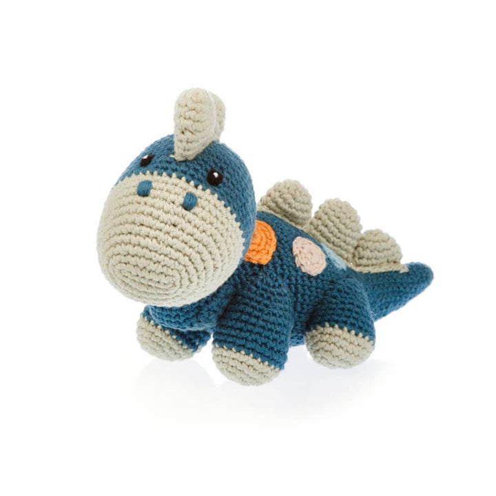 Crocheted dinosaur toy on a white background