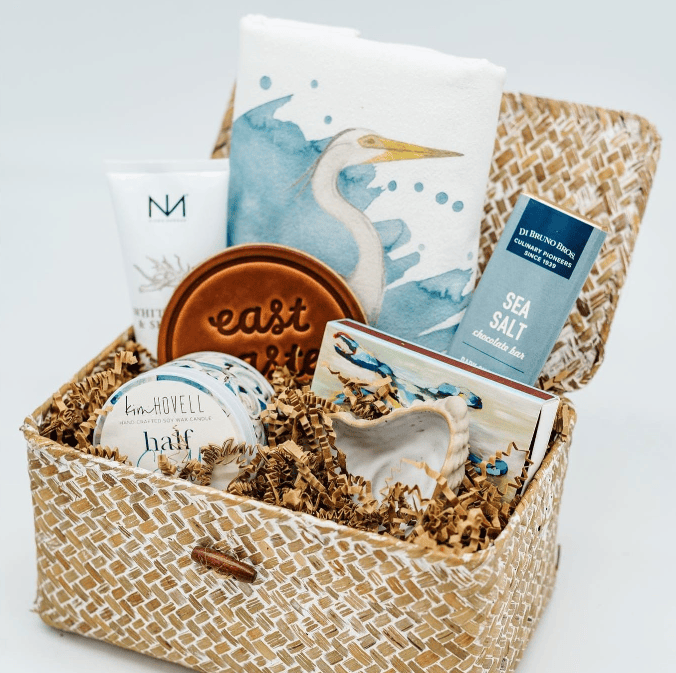 Gift basket with coastal-themed items including a book, coaster, and salt product.